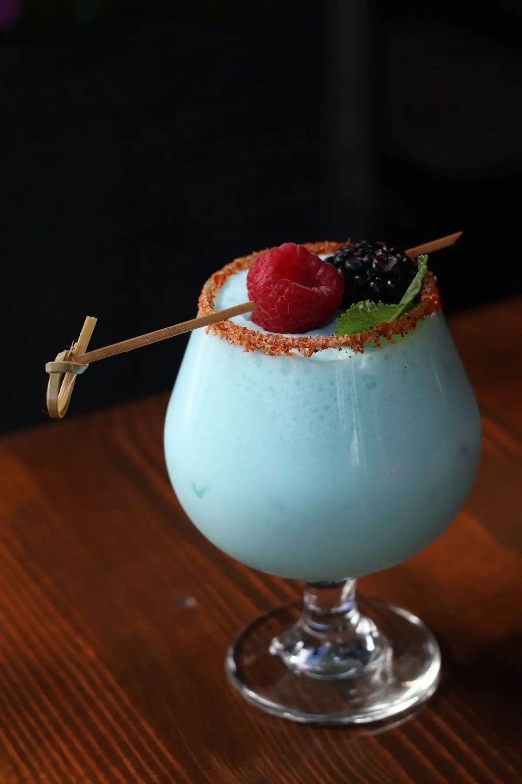 Blue cocktail with berries